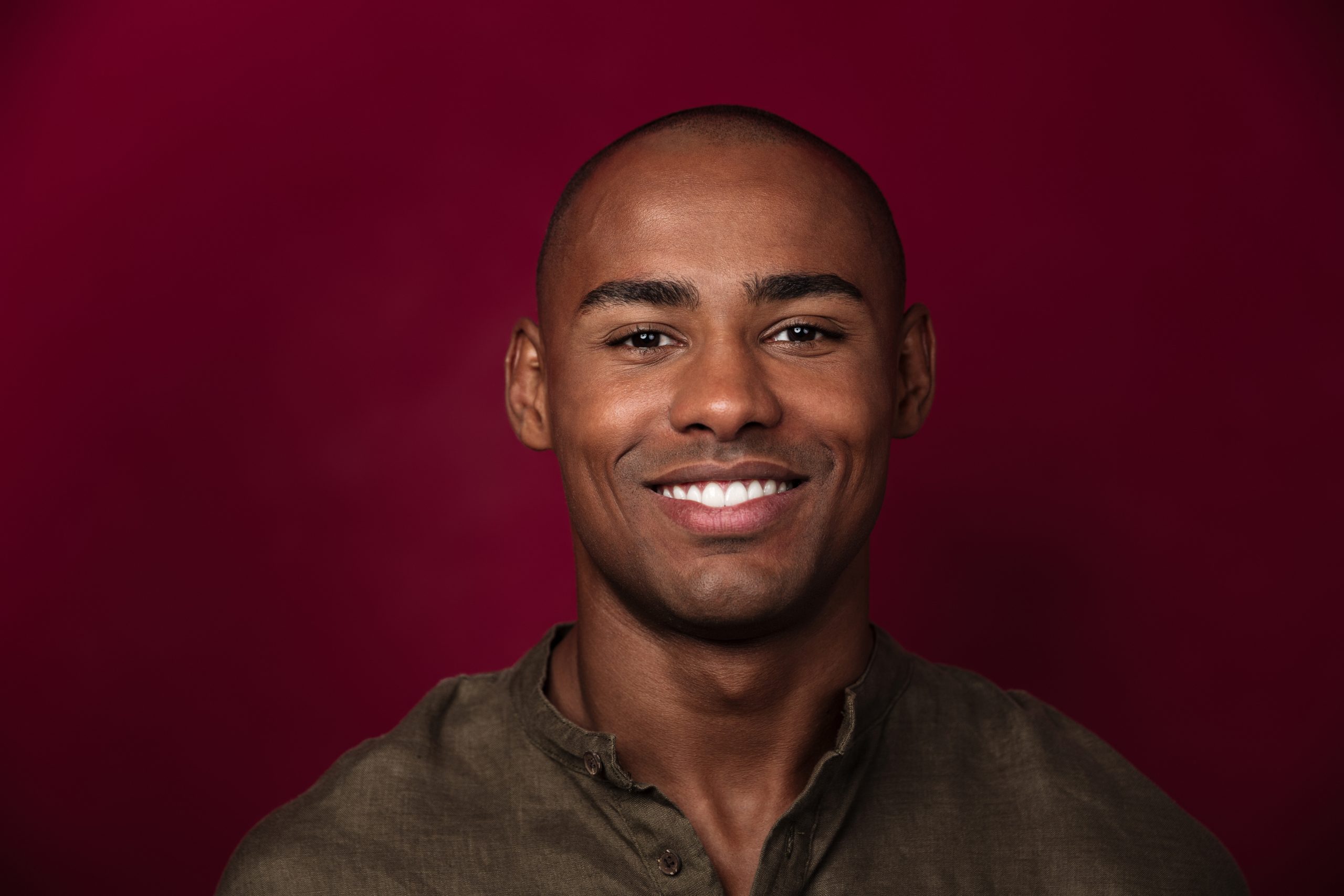 Home close up portrait of smiling african man looking at camera